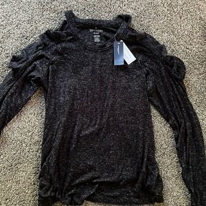 Brand new never worn Soft and sexy sweater with cut out ruffled shoulders